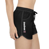 Side view of black iRaveBabe nylon festival shorts featuring “iRAVEBABE” text and Trippy Truffle mushroom logo